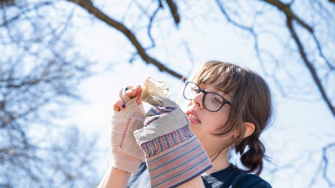 Claire Sammons looks at a shard of glass in the sunlight