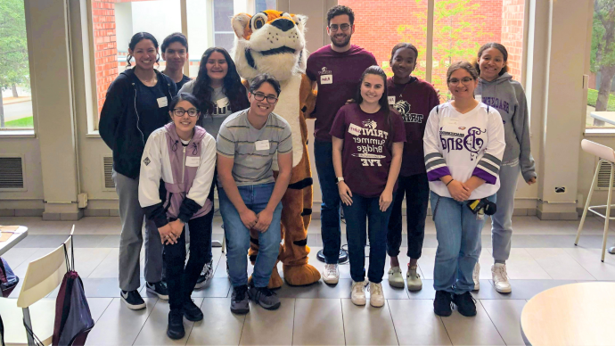 SAISD students pose with 澳门金沙线上赌博官网 counselors adn LeeRoy in Mabee Dining Hall on TCI Leadership Day 2022 