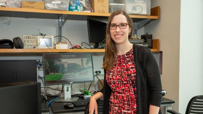 Professor Emma Treadway poses at desk