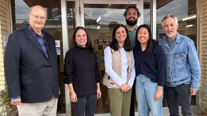 Faculty, students, and executives from the nonprofit Say Si stand in front of the Say Si campus downtown