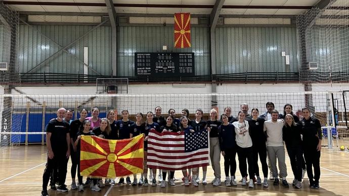 the 澳门金沙线上赌博官网 delegation 和 North Macedonian host representatives posed for a photo in a gym, holding up a USA flag 和 a North Macedonian flag