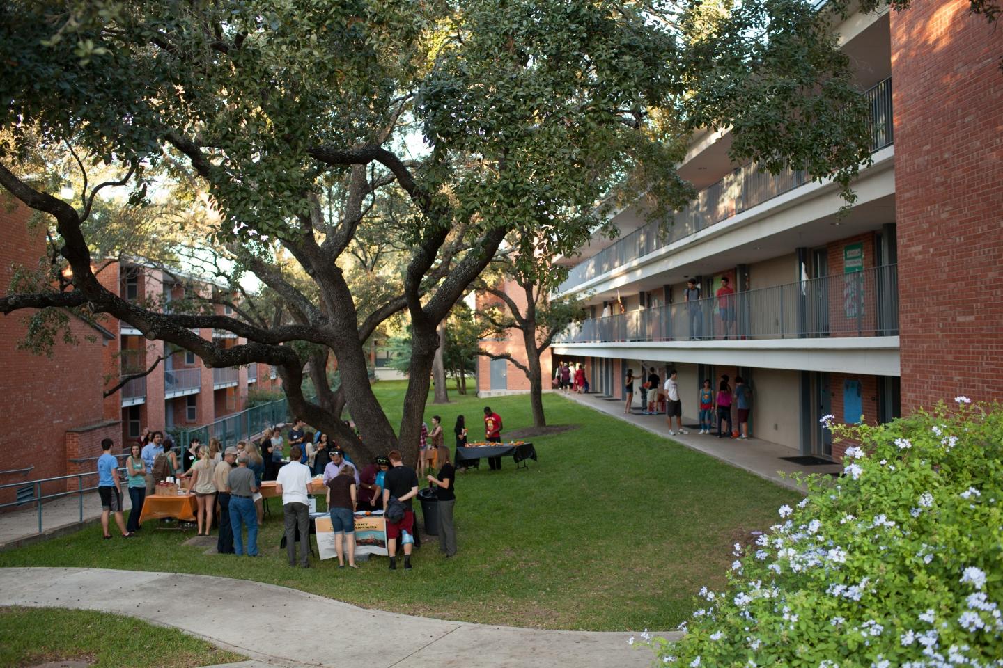 Students gathered around the picnic table outside of Miller Hall