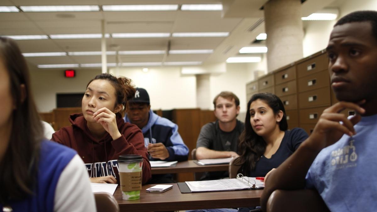 Students in classroom looking at professor