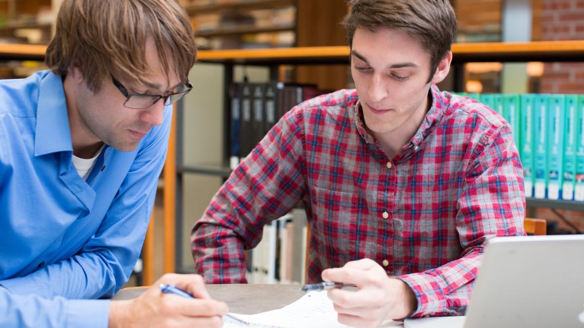 two students work together at a table