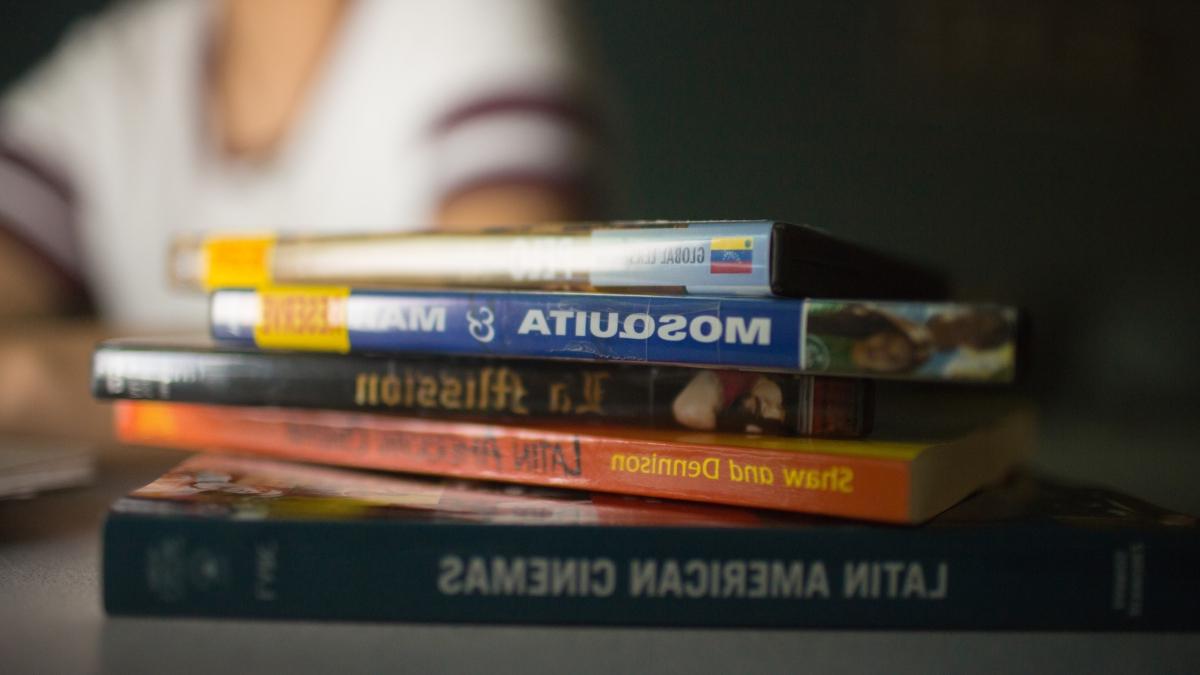 books stacked on a table in a dark room