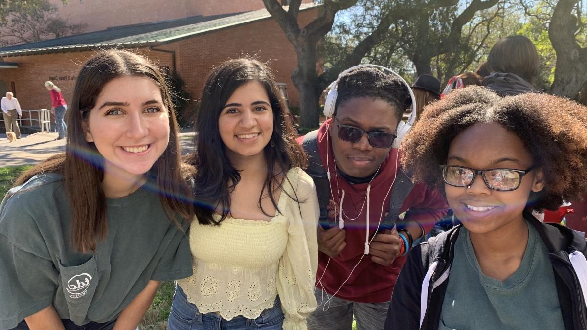 Group of four students posing together 